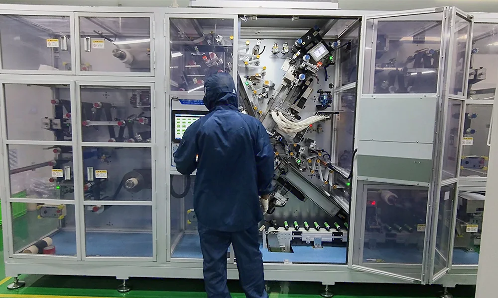 TOB engineer commissioning a 32140 tabless cylindrical cell winding machine